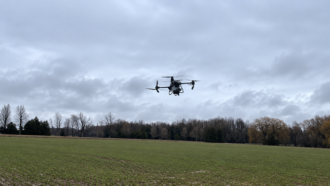An agricultural drone above a winter-wheat field in Ontario.