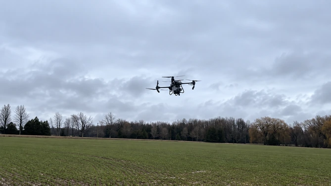 Drone in flight during the Ontario clover cover crop seeding work.