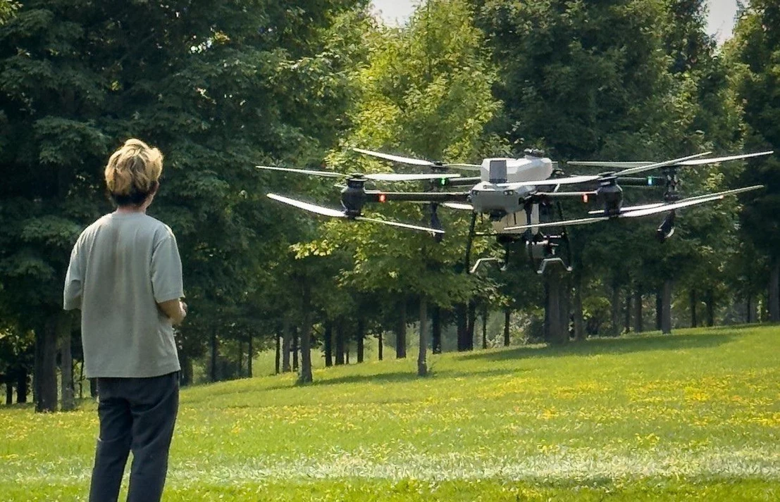 Practical field training and equipment testing beside an agricultural drone.