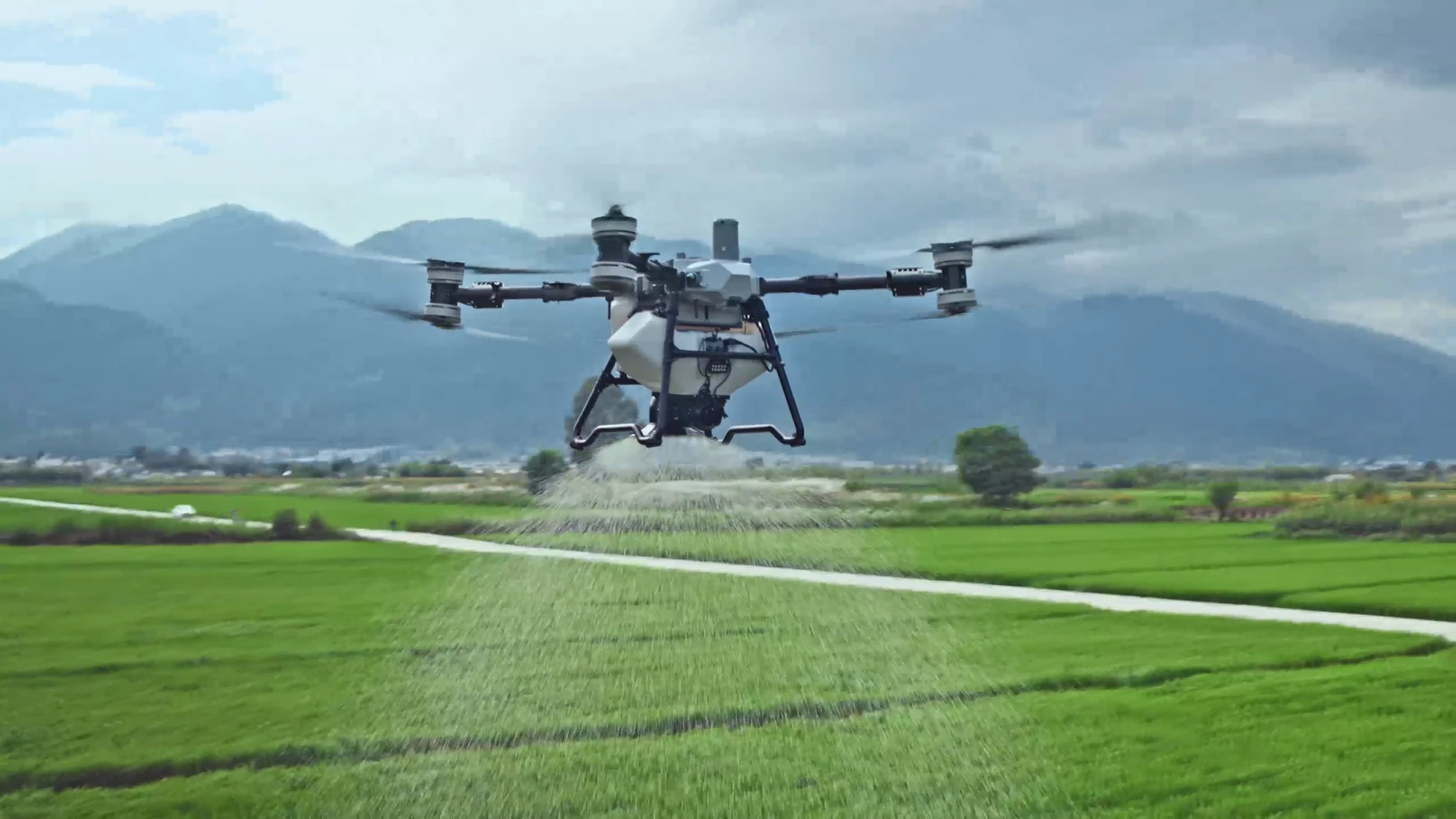 DJI agricultural drone equipped with a granular spreading system.