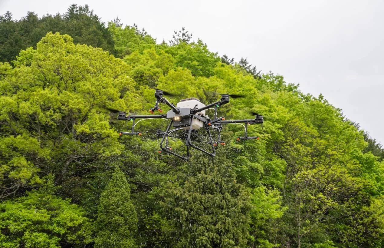 An agricultural drone carrying out granular spreading.