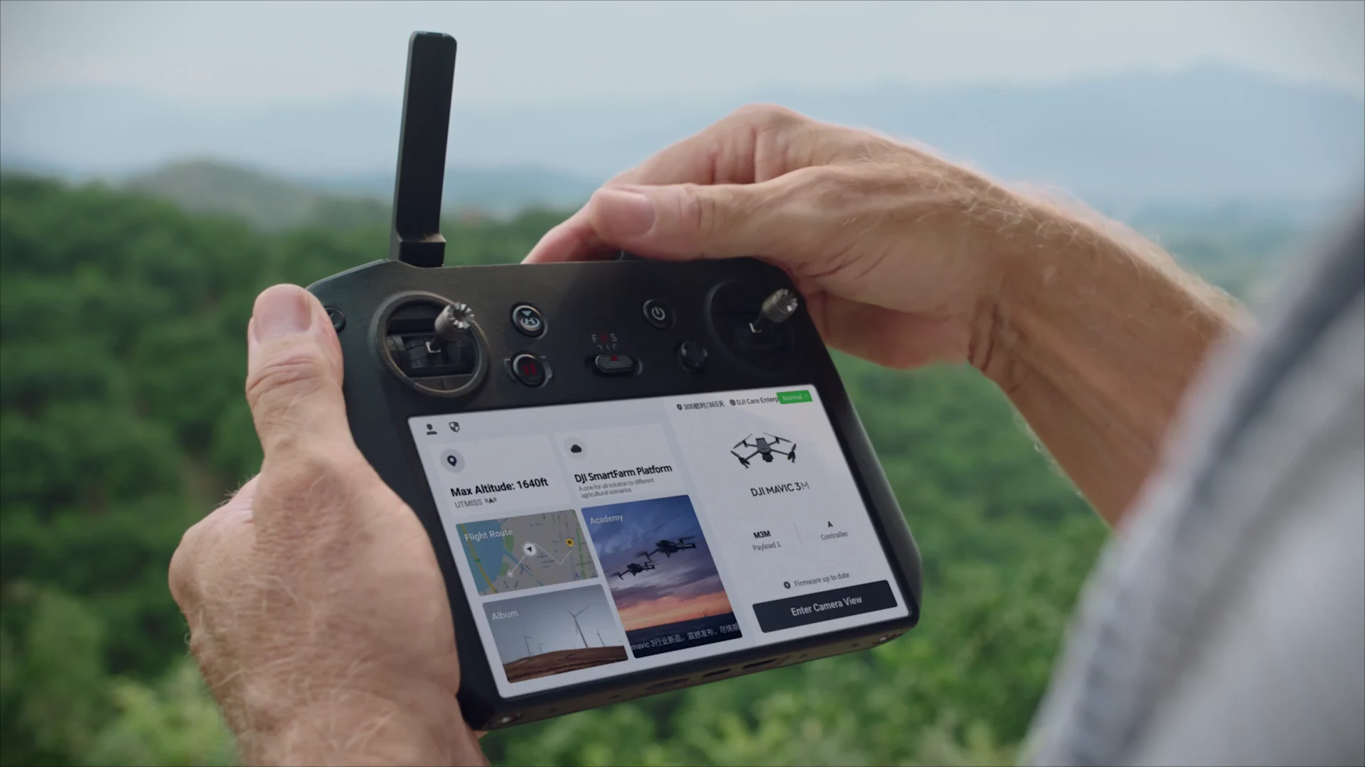 Hands holding a DJI controller during a manufacturer demonstration.